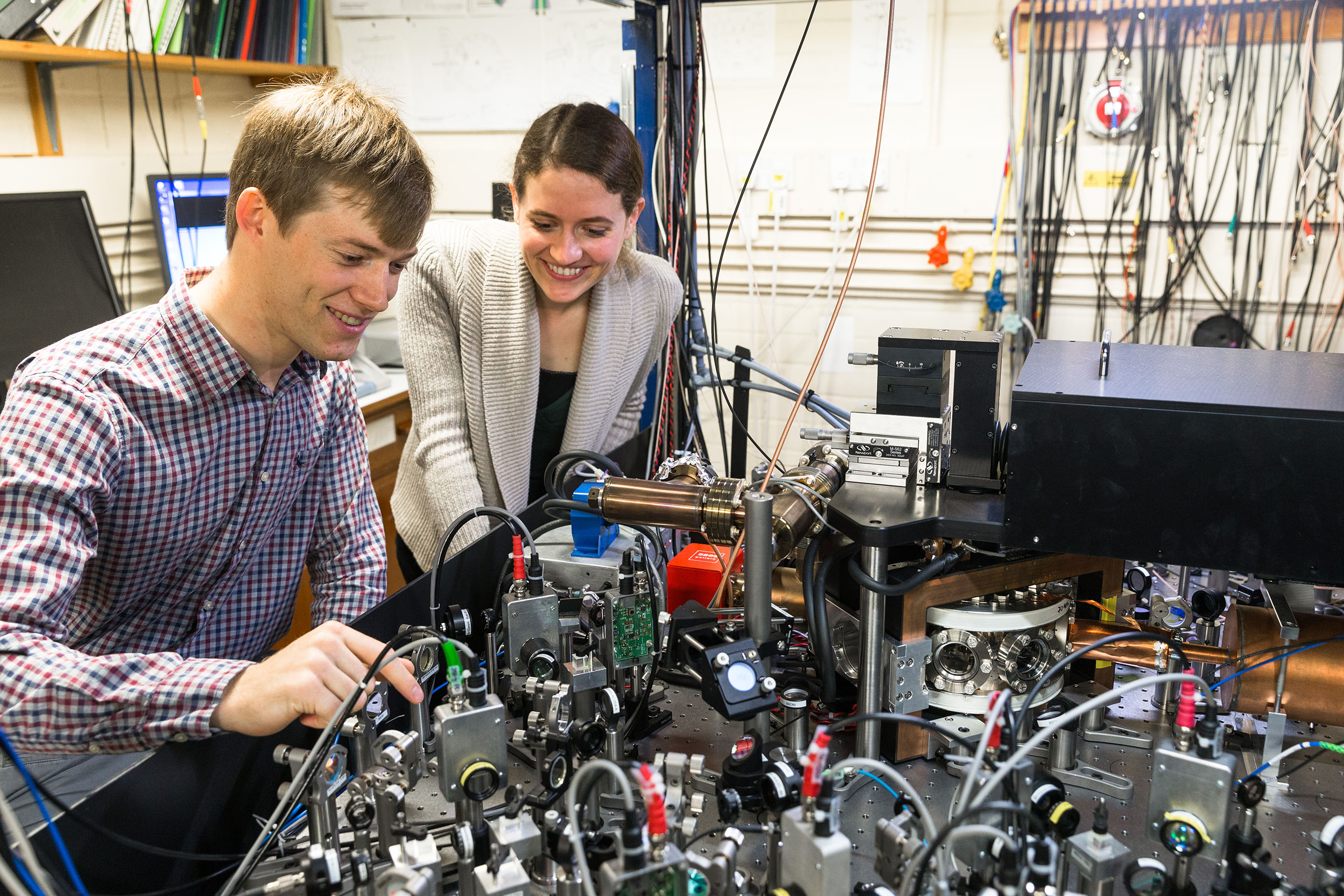 Lead authors, Vera Schäfer and Dr Chris Ballance, with the ion trap apparatus, Credit: David Fisher / NQIT Lead authors, Vera Schäfer and Dr Chris Ballance, with the ion trap apparatus, Credit: David Fisher / NQIT